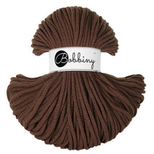 A skein of Bobbiny braided cord in a rich dark brown color, featuring a white paper label with the brand name 'Bobbiny' in black script, set against a plain white background.