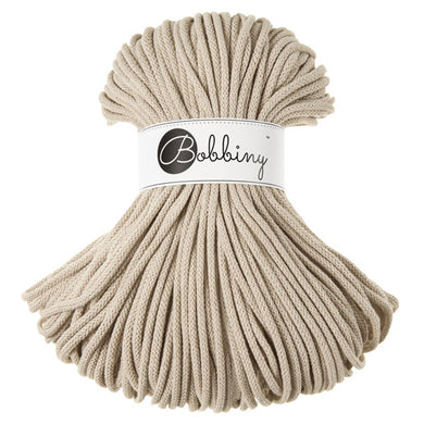 A bundle of textured beige cord wrapped with a white paper band featuring the brand name 'Bobbiny' in black script.