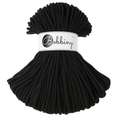 A bundle of black braided rope or cord with a white paper label around the middle that reads 'Bobbiny'.