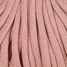 A close-up of blush pink braided cord  texture filling the frame.