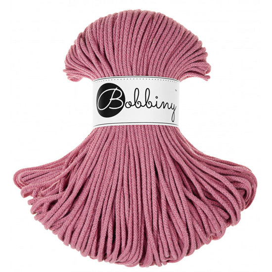 A bundle of pink braided cord with a white paper label wrapped around the center that reads 'Bobbing' in black script and logo, set against a plain white background.