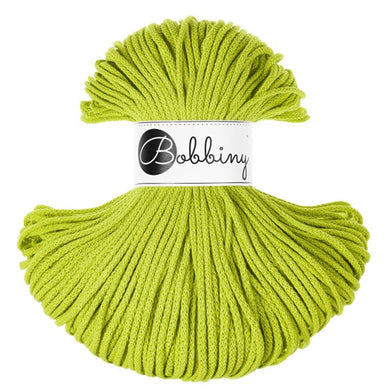 A skein of bright lime green braided cord with a white paper label in the center that reads 'Bobbiny' in black script and logo, set against a plain white background.