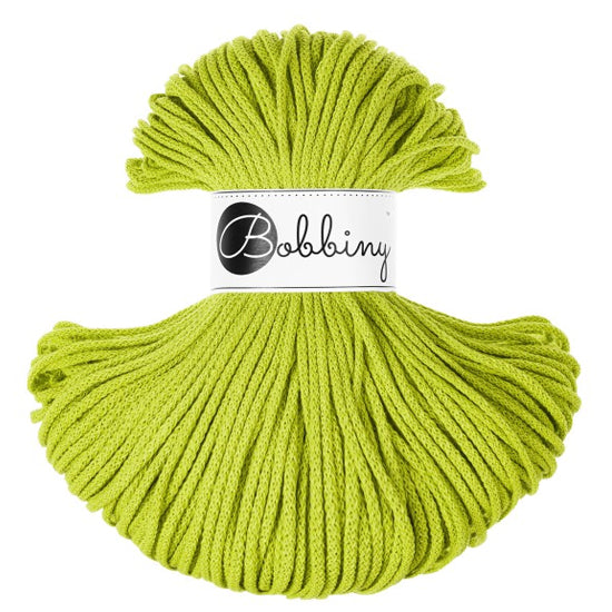 A skein of bright lime green braided cord with a white paper label in the center that reads 'Bobbiny' in black script and logo, set against a plain white background.