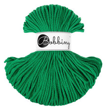 A skein of bright green braided cord  with a white paper label in the center that reads 'Bobbiny' in black script and logo, shown on a plain white background.