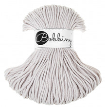 A skein of light gray braided cord with a white paper band around the middle that reads 'Bobbiny' in black script and logo, photographed on a plain white background.