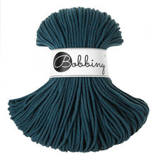 A skein of dark teal braided cord with a white paper label that reads 'Bobbiny' in black script, set against a plain white background.