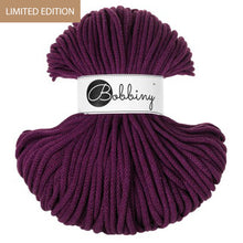 A skein of braided cord in a deep plum purple color, wrapped with a white paper label that reads 'Bobbiny'. A small tan banner in the top-left corner reads 'LIMITED EDITION'.
