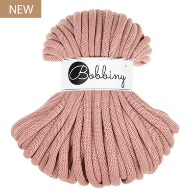 A blush pink chunky braided cord bundle with a white paper label reading 'Bobbiny' in black script, set against a plain white background with a small 'NEW' badge in the top-left corner.