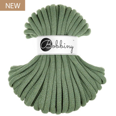 A skein of eucalyptus green braided cord with a white paper label reading 'Bobbiny' in black script, shown on a plain white background with a small 'NEW' badge in the top-left corner.