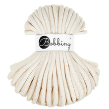 A skein of thick, cream-colored braided cord with a white paper label in the center that reads 'Bobbiny' in black script and logo, set against a plain white background.