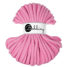 A pink braided cord bundle with a white paper label in the center that reads 'Bobbiny' in black script and logo, isolated on a white background.
