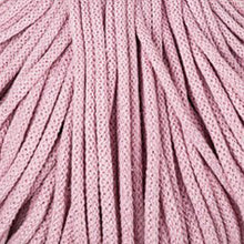 A close-up texture shot of dusty pink braided cord, filling the entire frame.