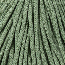 A close-up of eucalyptus green braided cord  texture filling the frame.