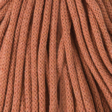 A close-up of braided cord in a warm rust-brown color, filling the entire frame.
