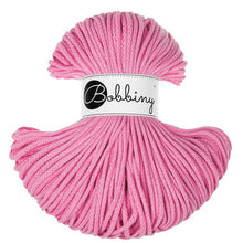 A skein of pink braided cord or rope with a white paper label in the center that reads 'Bobbiny' in black script, photographed on a plain white background.