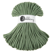 A bundle of eucalyptus green braided cord with a white paper label wrapped around the middle that reads 'Bobbiny'.