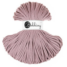 A skein of mauve braided cord with a white paper label in the center that reads 'Bobbiny'.
