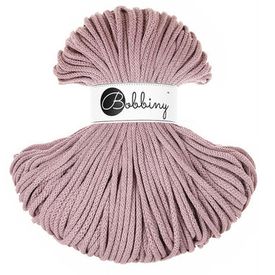A skein of mauve braided cord with a white paper label in the center that reads 'Bobbiny'.
