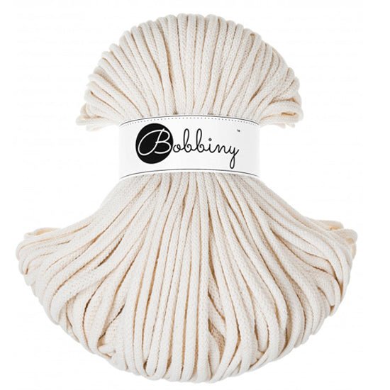 Ball of natural colored cord with a Bobbiny label on a white background