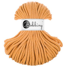 A bundle of thick, braided orange cord with a white paper label in the center that reads 'Bobbiny'.