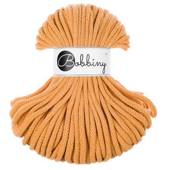 A bundle of thick, braided orange cord with a white paper label in the center that reads 'Bobbiny'.