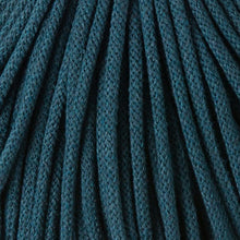 A close-up of dark teal braided cord  filling the entire frame with a textured weave pattern.