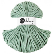 A bundle of aloe green braided cord with a white paper label in the center that reads 'Bobbiny'.