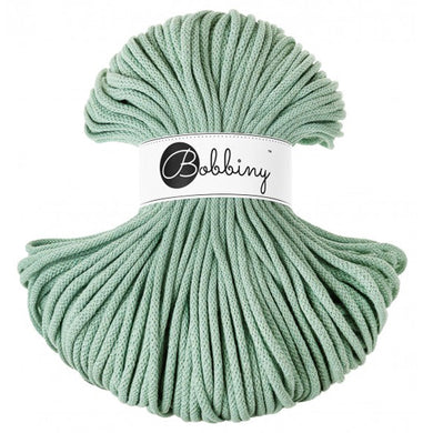 A bundle of aloe green braided cord with a white paper label in the center that reads 'Bobbiny'.