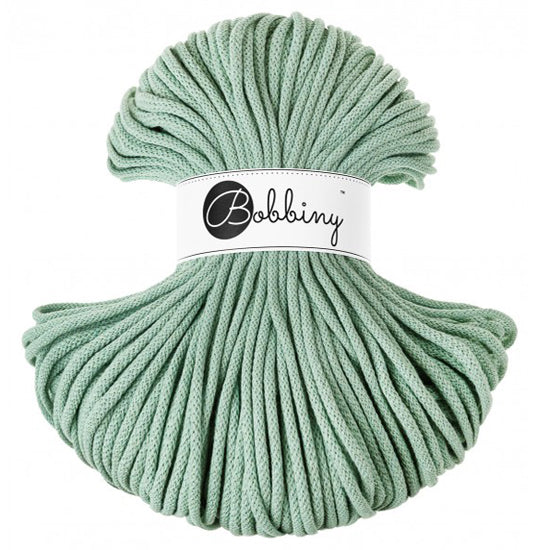 A bundle of aloe green braided cord with a white paper label in the center that reads 'Bobbiny'.