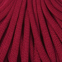 A close-up of dark red braided cord texture filling the frame.