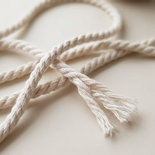 Close-up of natural 3mm 3ply recycled cotton macrame cord showing twisted strands and frayed ends